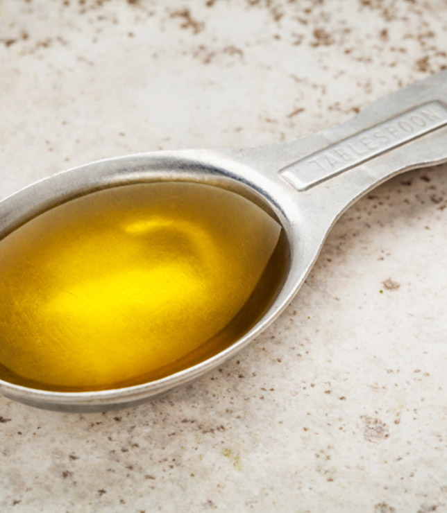 Close-up of a tablespoon full of canola oil