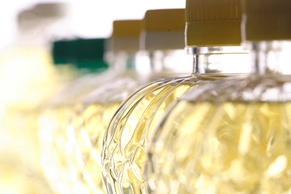 Several canola oil bottles with a blurred effect towards the background